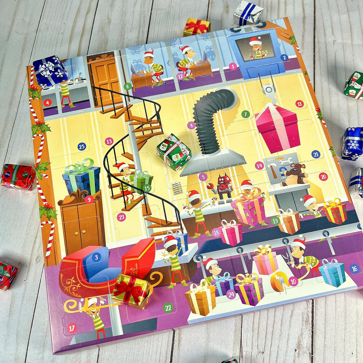 A colorful Factory 25 Piece Advent Calendar with various Christmas-themed illustrations, including presents, a Santa Claus figure, and a festive factory setting.