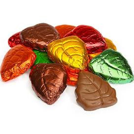 A variety of foil-wrapped chocolates designed to look like fall leaves, in colors such as red, orange, yellow, green, and burgundy.