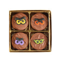 A box of chocolate covered Oreo cookies with Halloween themed decorations on top, displayed in a clear packaging.