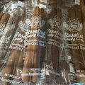 Packaged Rosalind Candy Co. chocolate covered pretzel rods in clear plastic packaging.