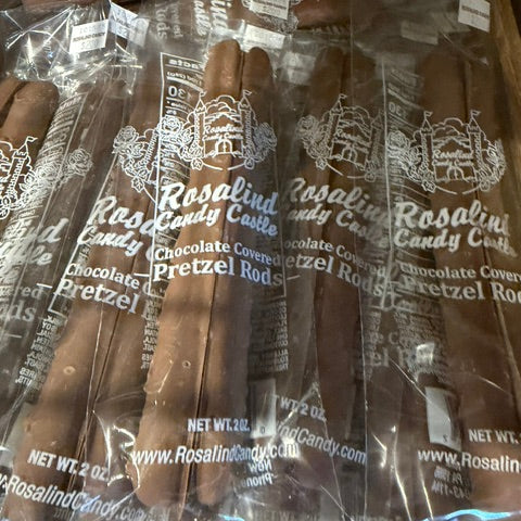Packaged Rosalind Candy Co. chocolate covered pretzel rods in clear plastic packaging.